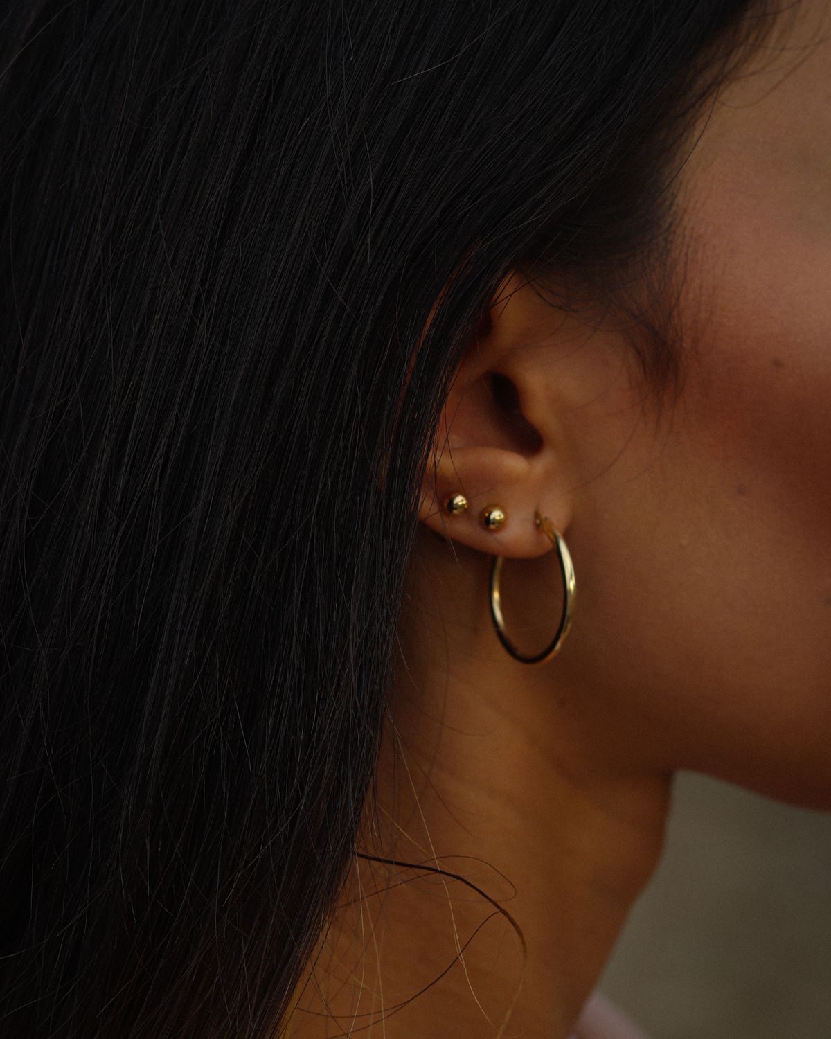 Gold hoop and stud earrings